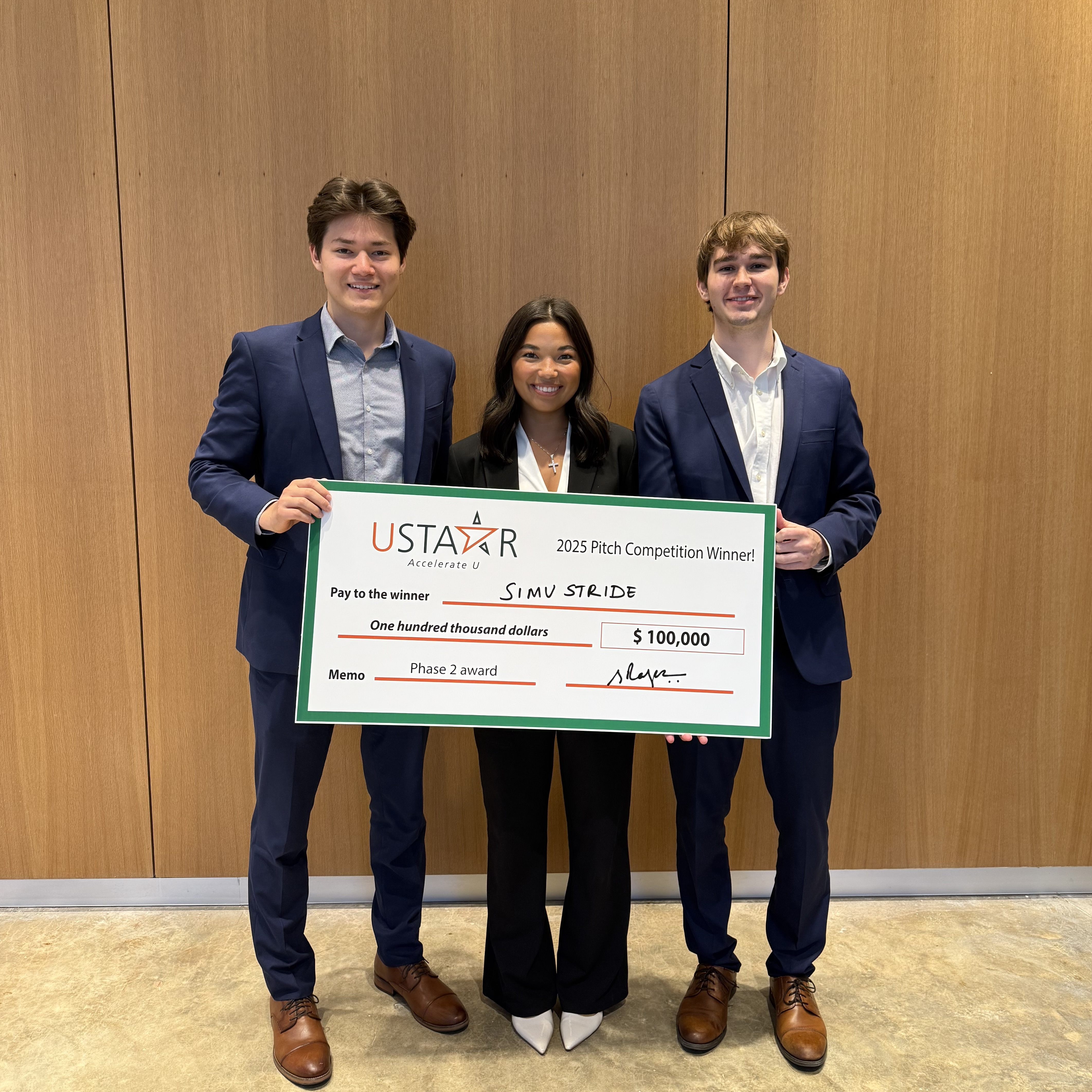 SimuStride team accepting the USTAAR Accelerator grand prize